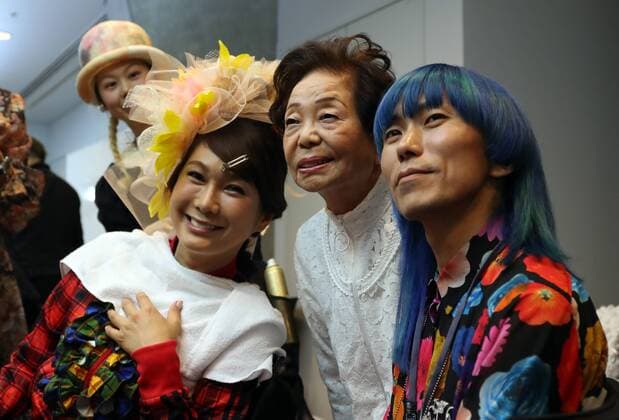 October 19, 2016, Tokyo, Japan - Former leprosy patient Miyo Maki (C) smiles with trangeder actress Ai Haruna (L) and designer Takafumi Tsuruta as they prepare for the tenbo 2017 spring summer collection as a part of Japan Fashion Week in Tokyo on Wednesday, October 19, 2016.  (lwxa005581)
