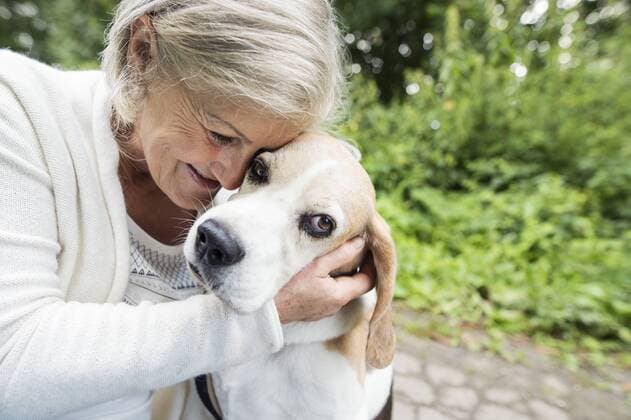 Happy senior woman cuddling her dog model released Symbolfoto property released  HAPF00889