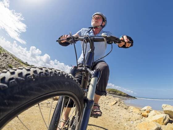 France, Brittany, senior man on electric mountainbike on coastal trail model released Symbolfoto  LAF01717