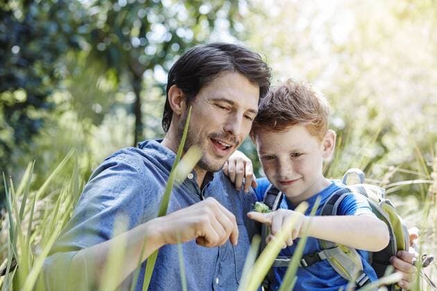 Father showing son a grasshopper model released Symbolfoto property released  RORF00340