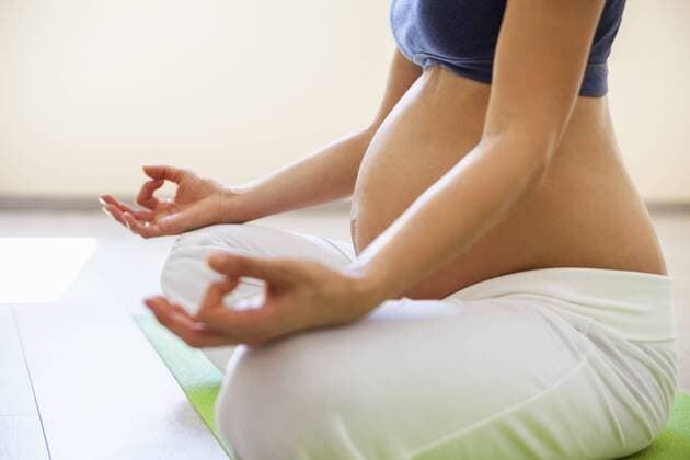 Prenatal yoga, woman meditating in lotus position model released Symbolfoto property released  ZEDF00337