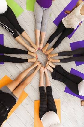 Legs of women in prenatal yoga class sitting together in circle model released Symbolfoto property released  ZEDF00370