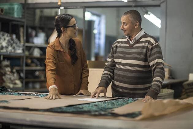 Tailor and fashion designer discussing cutting patterns model released Symbolfoto property released  ZEF10510