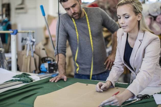 Fashion designer and tailor working together in workshop model released Symbolfoto property released  ZEF10662