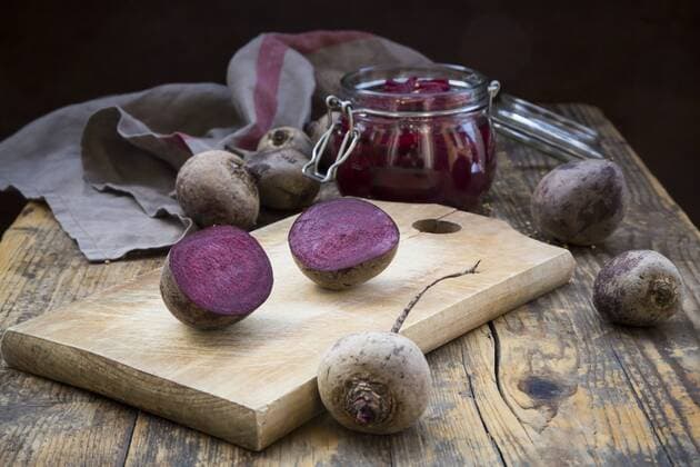 Whole and sliced beetroots and preserving jar of pickled beetroots  LVF05498