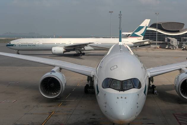 Airbus A350 and Boeing 777-300ER civil jet airplane of Cathay Pacific Airways pictured at Hong Kong International Airport, China LeonidxFaerberg 