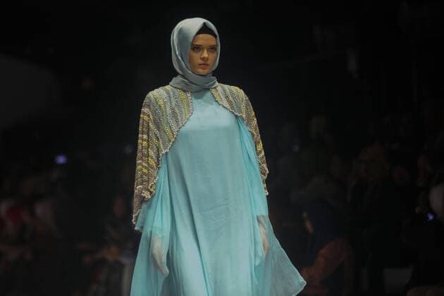 October 28, 2016 - Jakarta, Jakarta, Indonesia - A model walks on the runway to present Indonesian Muslim designer, Anniesa Hasibuan during the Jakarta Fashion Week in Jakarta, Indonesia, on October 28, 2016. Anniesa Hasibuan, 30, has made history by presenting the first ever collection at New York Fashion Week (NYFW) last month to feature hijabs in every look. She also the first Indonesian to have a show at an official NYFW venue. Her collection, called D Jakarta, featured headscarves in gold, silver and pink, metallic silver and gold long skirts, beaded shiny jackets and silky pants. Jakarta Indonesia - ZUMAn230 20161028_zaa_n230_327