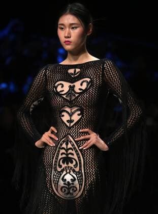 Chinese and European models wear clothing from the Lotus 2017 collection during China s international fashion week in Beijing on October 31, 2016. Chinese fashion designers are becoming an international force with both European and American fashion houses looking at the new, fresh Chinese clothing-minds as potential partners in future clothing brands.  PEK2016103131 STEPHENxSHAVER