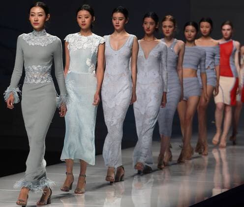Chinese and European models wear clothing from the Lotus 2017 collection during China s international fashion week in Beijing on October 31, 2016. Chinese fashion designers are becoming an international force with both European and American fashion houses looking at the new, fresh Chinese clothing-minds as potential partners in future clothing brands.  PEK2016103135 STEPHENxSHAVER
