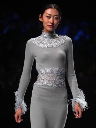 Chinese and European models wear clothing from the Lotus 2017 collection during China s international fashion week in Beijing on October 31, 2016. Chinese fashion designers are becoming an international force with both European and American fashion houses looking at the new, fresh Chinese clothing-minds as potential partners in future clothing brands.  PEK2016103109 STEPHENxSHAVER