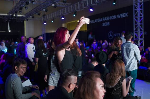 November 5, 2016 - Kuala Lumpur, MALAYSIA - A female audience take picture as model present creations during the Malaysia Fashion Week at Menara MATRADE in Kuala Lumpur, Malaysia on November 05, 2016. Kuala Lumpur MALAYSIA - ZUMAj91_ 20161105_zap_j91_005