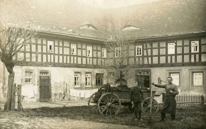 Two farmers in the courtyard of the farmhouse, Germany x17550x 