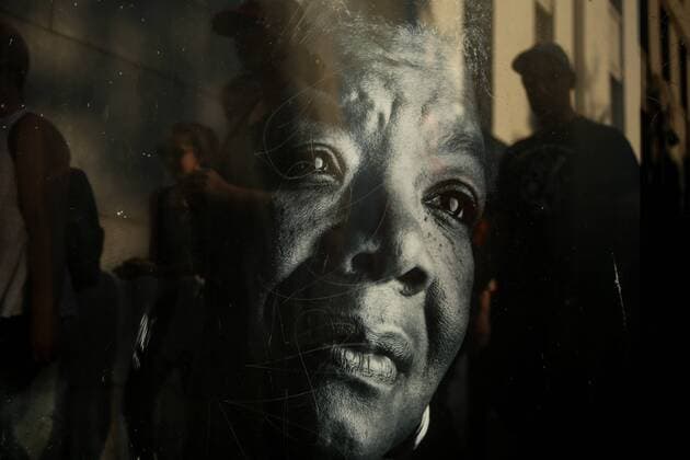 November 13, 2016 - Oakland, California, U.S - People walk past a bus stop poster of MAYA ANGELOU on 12th Street near Lake Merritt where protestors were gathering to join hands in a peaceful protest against President-elect Donald Trump in Oakland, California. Oakland U.S. - ZUMAj106 20161113_zap_j106_012