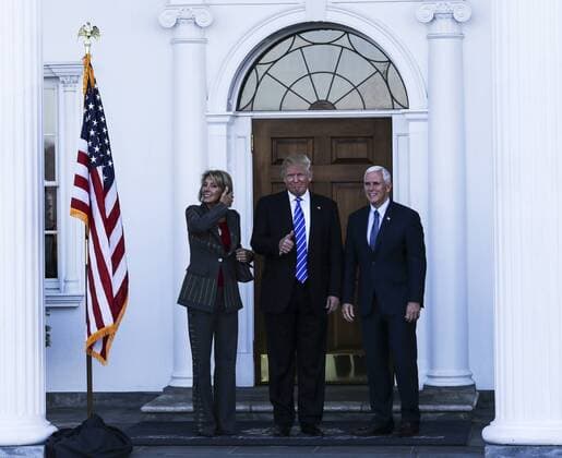 President-elect Donald Trump (C) and Vice President-elect Mike Pence (R) greet Betsy DeVos at the clubhouse of Trump International Golf Club, November 19, 2016 in Bedminster Township, New Jersey. DeVos is one of the biggest supporters of the Republican Party in the nation. Pool photo by Aude Guerrucc  TPX20161119217 AUDExGUERRUCCI