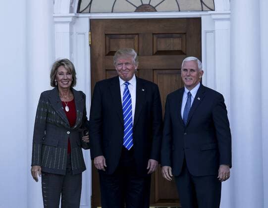 President-elect Donald Trump (C) and Vice President-elect Mike Pence (R) pose with Betsy DeVos at the clubhouse of Trump International Golf Club, November 19, 2016 in Bedminster Township, New Jersey. DeVos is one of the biggest supporters of the Republican Party in the nation. Pool photo by Aude Guerrucc  TPX20161119216 AUDExGUERRUCCI