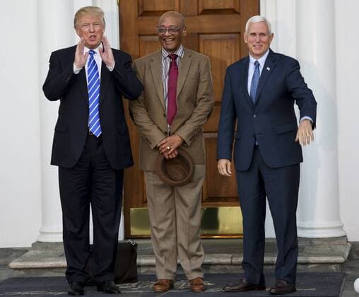 President-elect Donald Trump (L) and Vice President-elect Mike Pence (R) pose with Bob Woodson (C) at the clubhouse of Trump International Golf Club, November 19, 2016 in Bedminster Township, New Jersey. Robert L. Woodson Sr. heads the Center for Neighborhood Enterprise in Washington and advises House Speaker Paul D. Ryan (R-Wis.) on poverty issues. Pool photo by Aude Guerrucc  TPX20161119238 AUDExGUERRUCCI