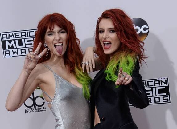 Actresses Dani Thorne (L) and Bella Thorne arrive for the 2016 American Music Awards held at Microsoft Theater in Los Angeles on November 20, 2016.  LAP20161120229 JIMxRUYMEN