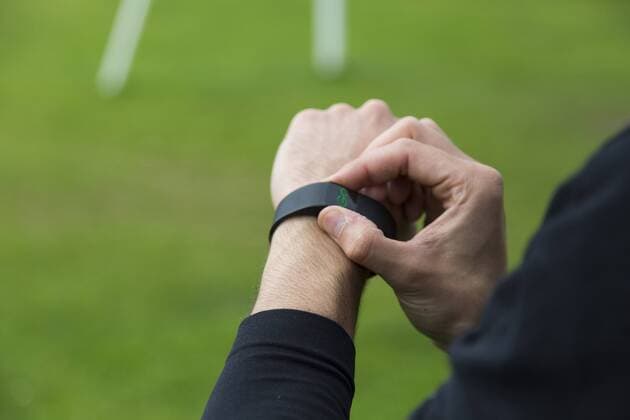 Jogger adjusting activity tracker model released Symbolfoto property released  BOYF00638