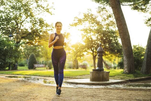 Young woman jogging in park at sunset model released Symbolfoto  EBSF01814