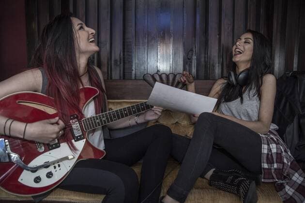 Two happy young women making music together model released Symbolfoto property released  ZEF10774