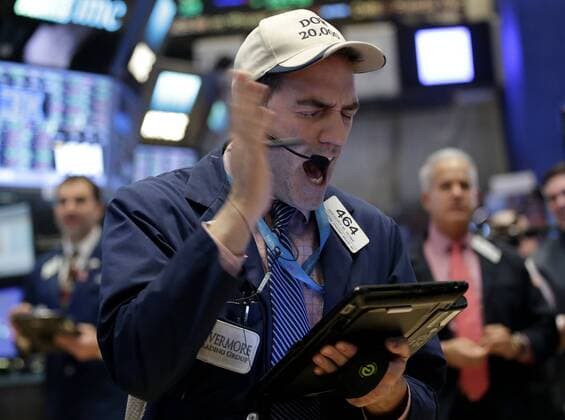 A trader wearing a DOW 20,000 hat works on the floor of the NYSE at the closing bell at the New York Stock Exchange on Wall Street in New York City on December 13, 2016. The Dow Jones Industrial Average closed up 114.78 points at a new all time high and less than 100 points away from 20,000 for the first time in history.  NYP20161213105 JOHNxANGELILLO