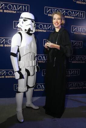 MOSCOW, RUSSIA - DECEMBER 14, 2016: Russian TV presenter and journalist Ksenia Sobchak (R) poses for a photograph with an actor dressed as a stormtrooper at the Moscow premiere of Rogue One: A Star War Story, a film by Gareth Edwards, in Moscow s Tesla 4000 multi-format workspace. Vyacheslav Prokofyev TASS  TS03AF9F