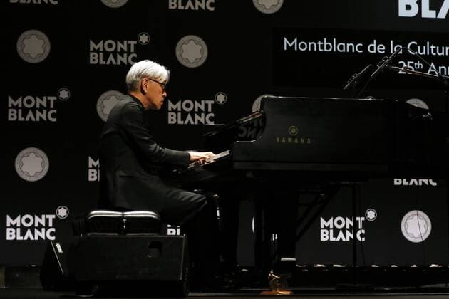 December 21, 2016, Tokyo, Japan - Japanese composer Ryuichi Sakamoto, a member of the Yellow Magic Orchestra (YMO) plays piano after he received Montblanc de la Culture Arts Patronage Award in Tokyo on Wednesday, December 21, 2016. Sakamoto played his screen music Merry Christmas Mr. Lawrence with young musicians.  (lwxa006989)