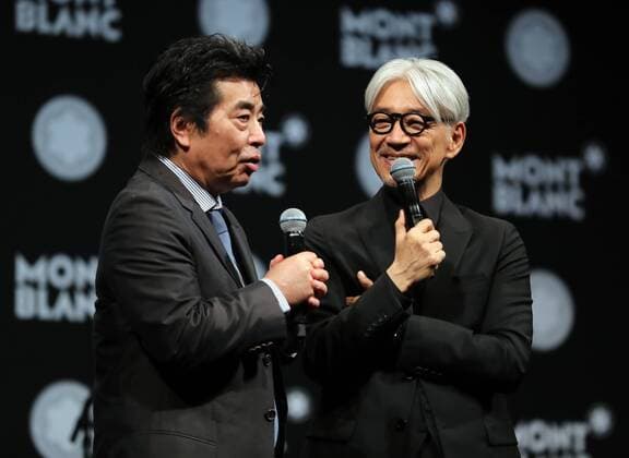 December 21, 2016, Tokyo, Japan - Japanese composer Ryuichi Sakamoto, a member of the Yellow Magic Orchestra (YMO) is celebrated from his friend and a Japanese author Ryu Murakami (L) after he received Montblanc de la Culture Arts Patronage Award in Tokyo on Wednesday, December 21, 2016. Sakamoto played his screen music Merry Christmas Mr. Lawrence with young musicians.  (lwxa006987)