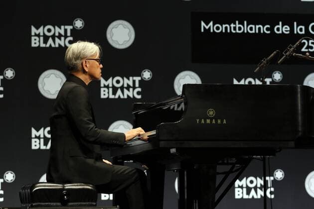 December 21, 2016, Tokyo, Japan - Japanese composer Ryuichi Sakamoto, a member of the Yellow Magic Orchestra (YMO) plays piano after he received Montblanc de la Culture Arts Patronage Award in Tokyo on Wednesday, December 21, 2016. Sakamoto played his screen music Merry Christmas Mr. Lawrence with young musicians.  (lwxa007008)