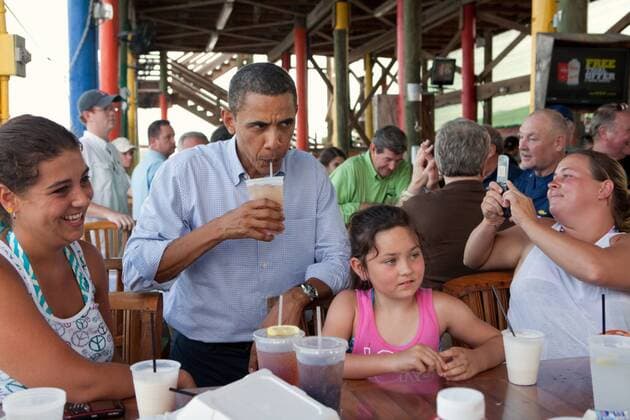 Jul. 21, 2010 - Fort Morgan, AL - President Barack Obama sips an iced tea while talking to patrons at Tacky Jack s, a seafood restaurant in Orange Beach, Ala., during his tour of the Gulf Coast, June 14, 2010. This was the President s fourth trip to the Gulf Coast to assess the ongoing response to the BP oil spill in the Gulf of Mexico. Barack Hussein Obama II (born August 4, 1961) is the 44th President of the United States. He is the first African American to be elected to office and the first president born outside the contiguous United States. Born in Honolulu, Hawaii, Obama is a graduate of Columbia University and Harvard Law School. He worked as a civil rights attorney and taught constitutional law at the University of Chicago Law School from 1992 to 2004. While serving three terms representing the 13th District in the Illinois Senate from 1997 to 2004, he ran unsuccessfully in the - ZUMAz03_ 20100721_shh_z03_840