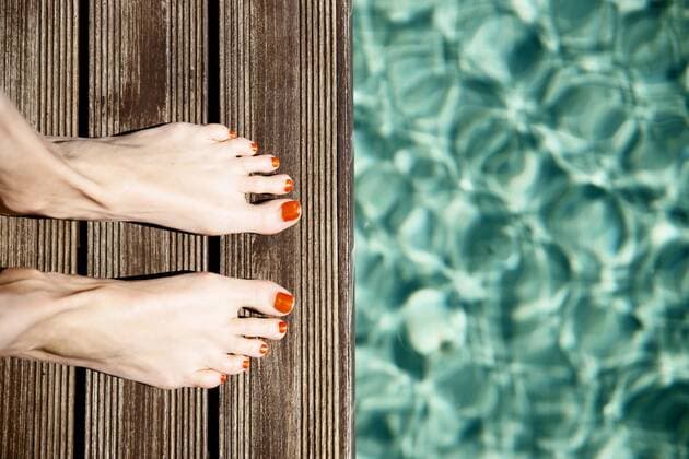 Female feet standing at pool s edge model released Symbolfoto  CHPF00331