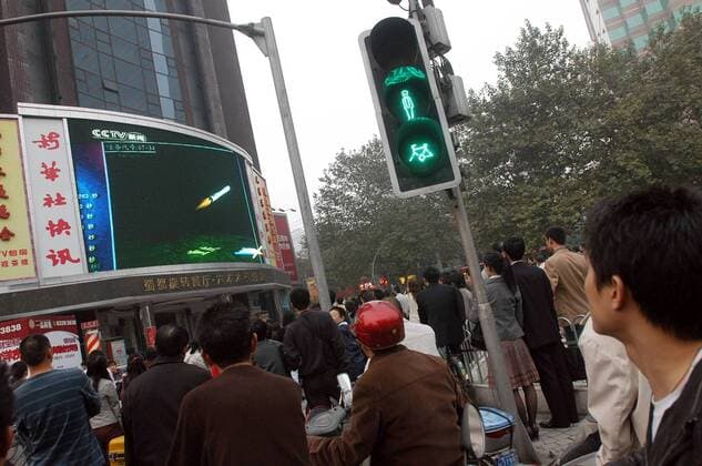 Oct 24, 2007 - Chengdu, Sichuan, China - Local residents watch a screen showing the Long March 3A rocket carrying China s first lunar orbiter, the Chang e I, blasting off from the Xichang Satellite Launch Centre, in Chengdu. China s first moon probe, the satellite Chang e I took off at 6:05pm as scheduled in the center in southwestern Sichuan Province, a major step in the country s plans to eventually land a spacecraft on the moon. The orbiter is expected to relay the first picture of the moon in late November and will also carry out a series of projects including acquiring 3-D images and analyzing the distribution of elements on the moon s surface during a year-long lunar exploration.  - ZUMAc32_ 20071024_jab_c32_763