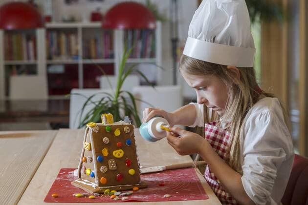 Girl garnishing gingerbread house model released Symbolfoto property released  SARF03089