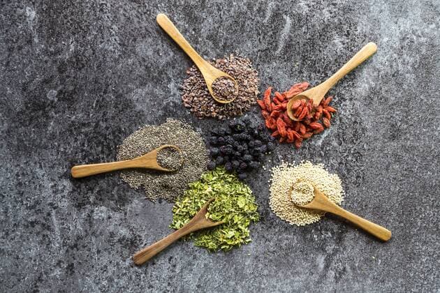 Wooden spoons of chokeberries, chia, aronia, quinoa, moringa and wolfberries  SARF03109