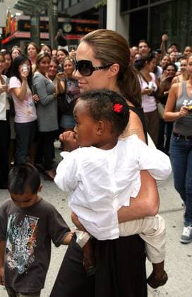 August 24 2007, New York City Angelina Jolie and Brad Pitt took their adopted children Zahara, Pax and Maddox for a trip to Lee s Art Shop in midtown Manhattan, bought them toys and gifts and then stopped in Times square on the way back to their hotel, where Brad bought Maddox a pretzel - ZUMAny2_ 20070824_zaf_ny2_023
