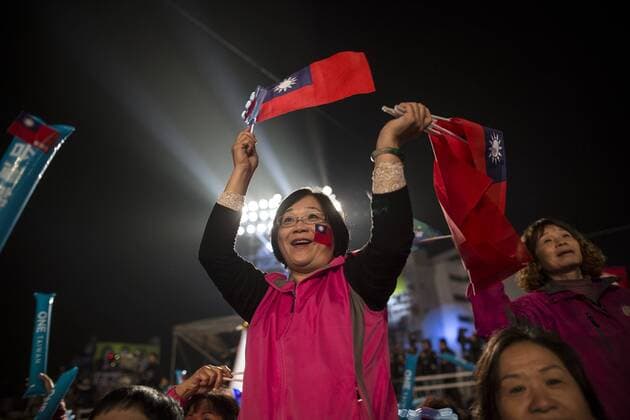 Taiwan: Presidential election (KMT) Kuomintang supporter holding flag in the election campaign. General elections were held in Taiwan on 16 January 2016 in order to elect the 14th President of the Republic of China and the 113 members of the 9th Legislative Yuan. Tsai Ing-wen of the Democratic Progressive Party (DPP) was elected to be the President with 56% of the votes and became the first female president in the history of Taiwan.  ChanxLongxHei