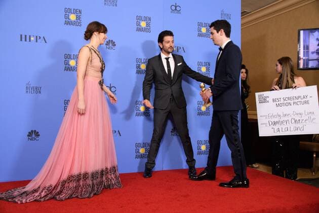 Jan 8, 2017 - Beverly Hills, California, U.S - After winning the category of BEST SCREENPLAY MOTION PICTURE for La La Land, DAMIEN CHAZELLE (R) poses backstage in the press room with the Golden Globe Award and presenters FELICITY JONES and DIEGO LUNA at the 74th Annual Golden Globe Awards at the Beverly Hilton in Beverly Hills, CA on Sunday, January 8, 2017. Beverly Hills U.S - ZUMAz03_ 20170108_sha_z03_475