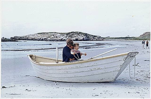 September 15, 1963 - Newport, Rhode Island, United States of America - United States President John F. Kennedy plays with his son, John F. Kennedy, Jr., in beached rowboat during a weekend on Bailey s Beach in Newport, Rhode Island on September 15, 1963..Credit: via CNP Newport United States of America - ZUMAs152 19630915_zaa_s152_001