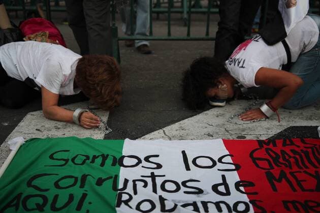 January 9, 2017 - Mexico City, Mexico - Women kiss the feet of Demonstrators wearing masks of the ex president Salinas De Gortari and the Mexican president Enrique PeoÂ±a Nieto outside Natioal palace of Mexico City, on 9 January 2017, as a way to protest against fuel prices in Mexico the 9 of January of 201.Largely peaceful protests against the fuel price increases continued nationwide in Mexico, and looting seen last week largely subsided. The protests have left hundreds of businesses looted and more than 1,500 detained. Mexico City Mexico  - ZUMAn230 20170109_zaa_n230_049