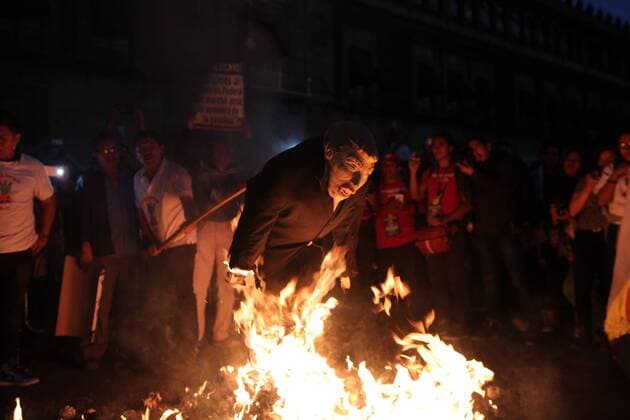 January 9, 2017 - Mexico City, Mexico - Demonstrators burned a figure of Donald Trump, and the Mexican President Enrique PeoÂ±a Nieto in front of Nacional Palace of Mexico City, on 9 January 2017. As a part of the demonstration against fuel prices in all the country. Largely peaceful protests against the fuel price increases continued nationwide in Mexico, and looting seen last week largely subsided. The protests have left hundreds of businesses looted and more than 1,50 Mexico City Mexico  - ZUMAn230 20170109_zaa_n230_059