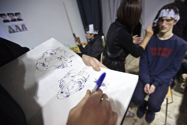 MILAN, Jan. 16, 2017 -- A man draws a sketch for a model at backstage ahead of the Fall Winter 2017 18 menswear collection of MIAORAN by Chinese designer Miao Ran during Milan Fashion Week in Milan, Italy, on Jan. 16, 2017. )(gl) ITALY-MILAN-FASHION WEEK-MEN-CHINESE DESIGNER-MIAORAN JinxYu 