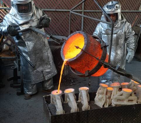Workers in fire suits pour molten bronze metal into molds during the casting of the Screen Actors Guild Award statuettes at the American Fine Arts Foundry in Burbank, California on January 17, 2017. Winners are to be announced during a live simulcast on TNT and TBS in Los Angeles on January 29, 2017.  LAP2017011710 JIMxRUYMEN