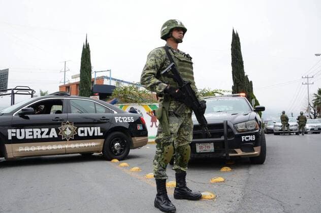 (170118) -- MONTERREY (MEXICO), Jan. 18, 2017 -- A security member stands guard outside the American School of the Northeast where a shooting occurred in Monterrey, Nuevo Leon state, Mexico, on Jan. 18, 2017. At least five people, including four teenagers and one teacher, were critically injured early Wednesday, after a student opened fire in their classroom at the private school. ) MEXICO-MONTERREY-SCHOOL-SHOOTING STR 