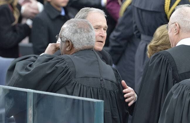 Former President George Bush hugs Supreme Court Justice Clarence Thomas on arrival for the inauguration ceremony at the Capitol on January 20, 2017 in Washington, D.C. Trump becomes the 45th President of the United States.  WAP2017012020 MIKExTHEILER