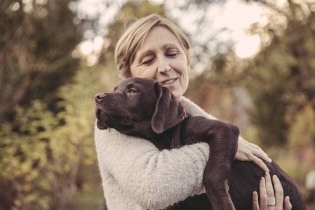 Woman holding Labrador Retriever model released Symbolfoto property released  MFF03395
