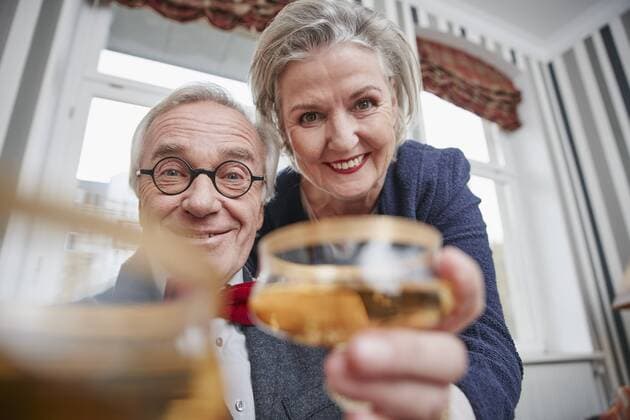 Portrait of happy senior couple holding champagne glasses model released Symbolfoto property released  RHF01758