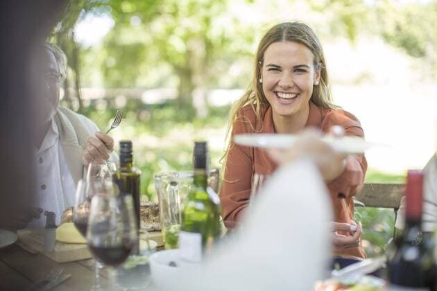 Smiling woman at family lunch in garden model released Symbolfoto property released  ZEF12392