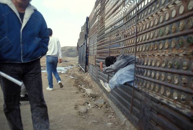 January 25, 2107 - File - President Trump signed executive orders to begin the construction of a wall on the US-Mexico border, boosting border patrol forces and increasing the number of immigration enforcement officers who carry out deportations. Pictured: Aug 05, 1999 - San Diego, California, USA - In March of 2006 the Pew Hispanic Center estimated the undocumented population ranged from 11.5 to 12 million individuals, a number supported by the US Government Accountability Office. Pew estimated that 57% of this population comes from Mexico and about half of them are illegal; 25% from Central America and, to a much lesser extent, South America; 9% from Asia; 6% from Europe, and the remaining 4% from elsewhere. PICTURED: An illegal immigrant crosses the border wall. San Diego USA - ZUMAa05_ 20170125_sho_a05_088 Copyright: xJamesxAronovskyx