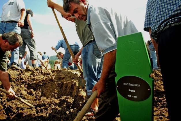 July 8, 2005 - U.S. - KRT WORLD NEWS STORY SLUGGED: BOSNIA KRT PHOTOGRAPH BY LAURIE SKRIVAN ST. LOUIS POST-DISPATCH (BELLEVILLE NEWS-DEMOCRAT, ALTON TELEGRAPH AND EDWARDSVILLE INTELLIGENCER OUT) (July 11) SREBRENICA, BOSNIA -- Hajrudin Husic buries his father-in-law, Nezir Music, a victim of the Massacre of Srebrenica in July 1995. An estimated 50,000 people attended the 10th anniversary service in Srebrenica, Bosnia, on July 11, 2005. (cdm) 2005 - ZUMAm67_ 20050708_baf_m67_028 Copyright: xLauriexSkrivanx