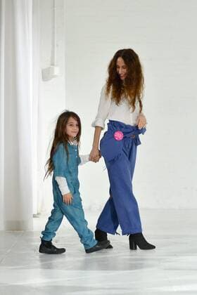 Designer Mara Hoffman walks off stage with her daughter after her fashion show at New York Fashion Week: The Shows at Shop Studios on February 13, 2017 in New York City.  NYP201702131028 ANDREAxHANKS